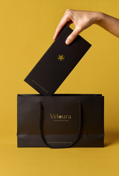 Veloura packaging held by a person